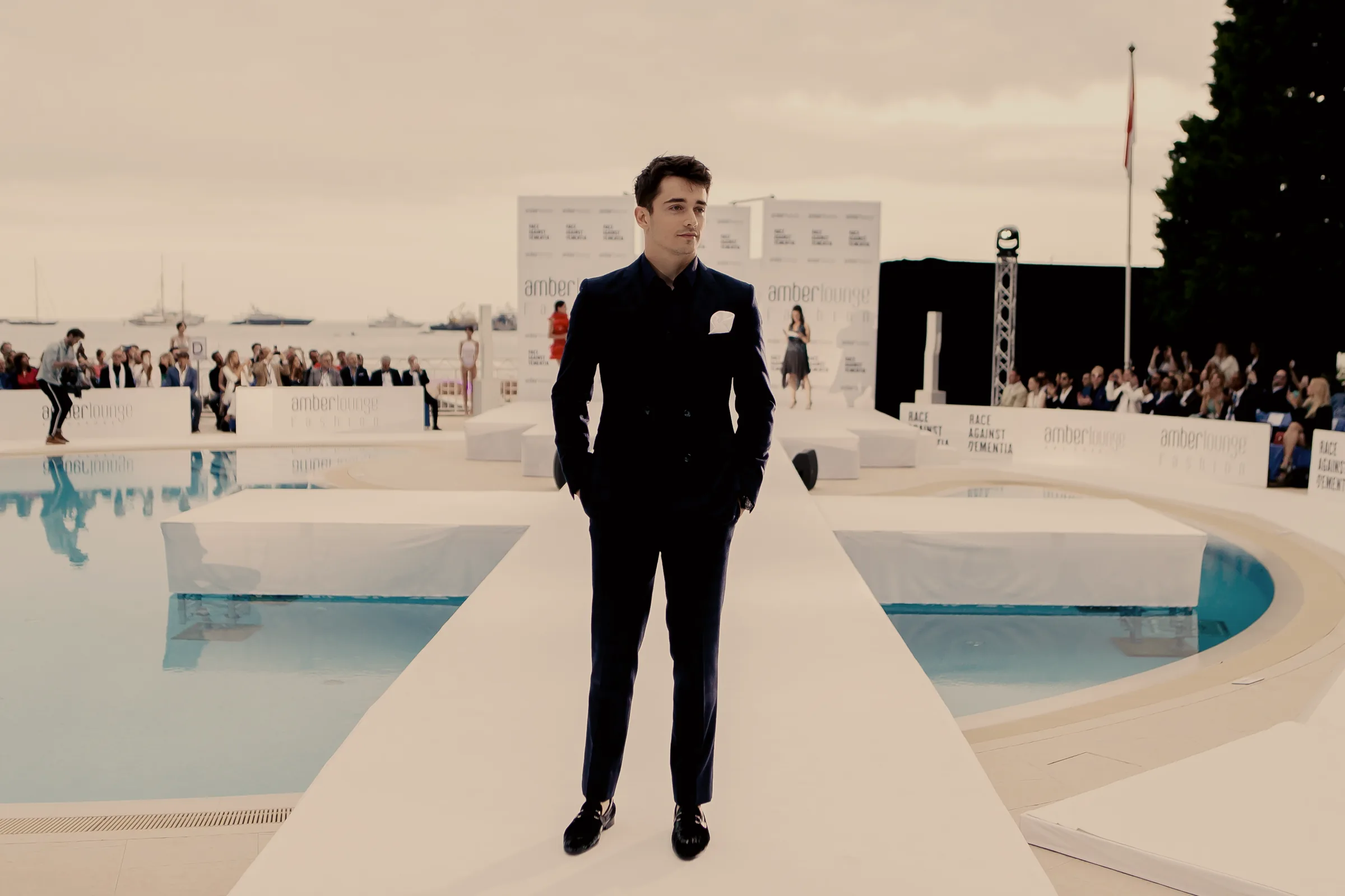 Charles Leclerc walks the runway at the Amber Lounge Fashion Show